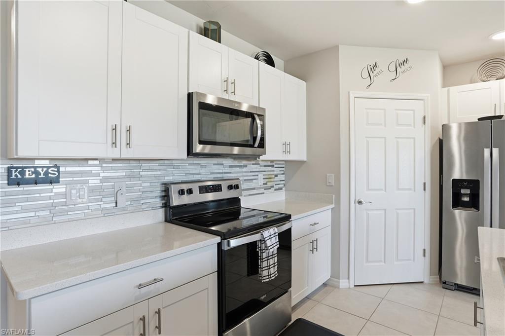 4121 68th Avenue Northeast Naples, FL 34120 - Photo 3 of 33 a kitchen with cabinets stainless steel appliances and a counter space