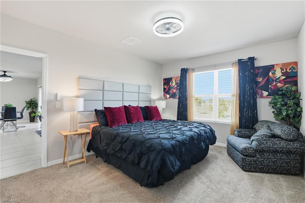 4121 68th Avenue Northeast Naples, FL 34120 - Photo 7 of 33 a bedroom with a large bed and a window