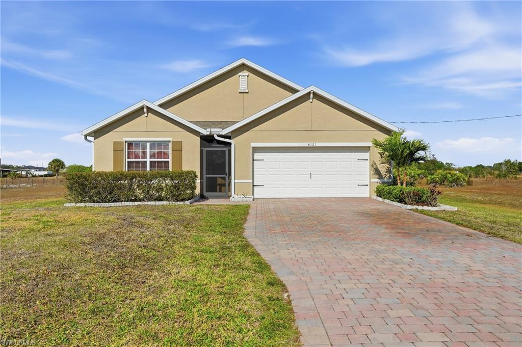 4121 68th Avenue Northeast Naples, FL 34120 - Photo 8 of 33 a front view of a house with a yard and garage