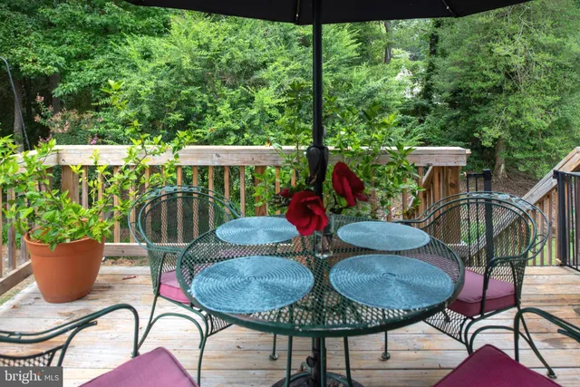 a view of a hallway with wooden floor and closet