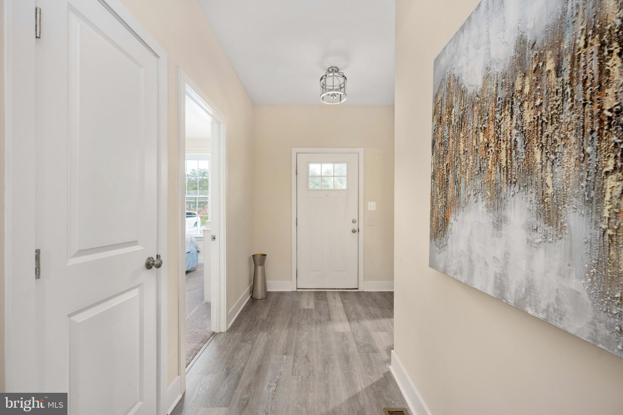 137 12th Street Colonial Beach, VA 22443 - Photo 19 of 66 a view of a hallway with wooden floor and a bathroom