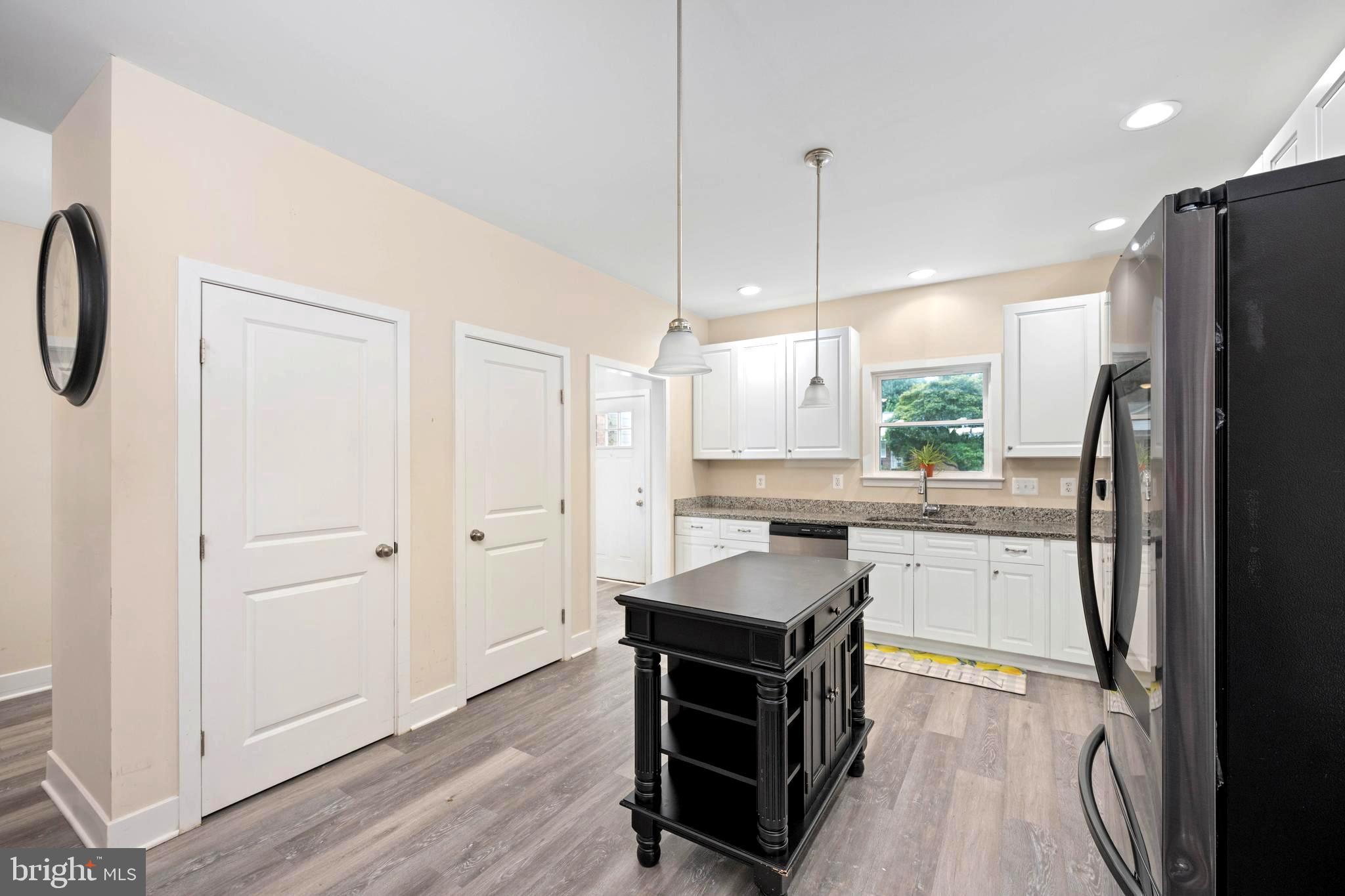 137 12th Street Colonial Beach, VA 22443 - Photo 25 of 66 a kitchen with a refrigerator a sink and wooden floor