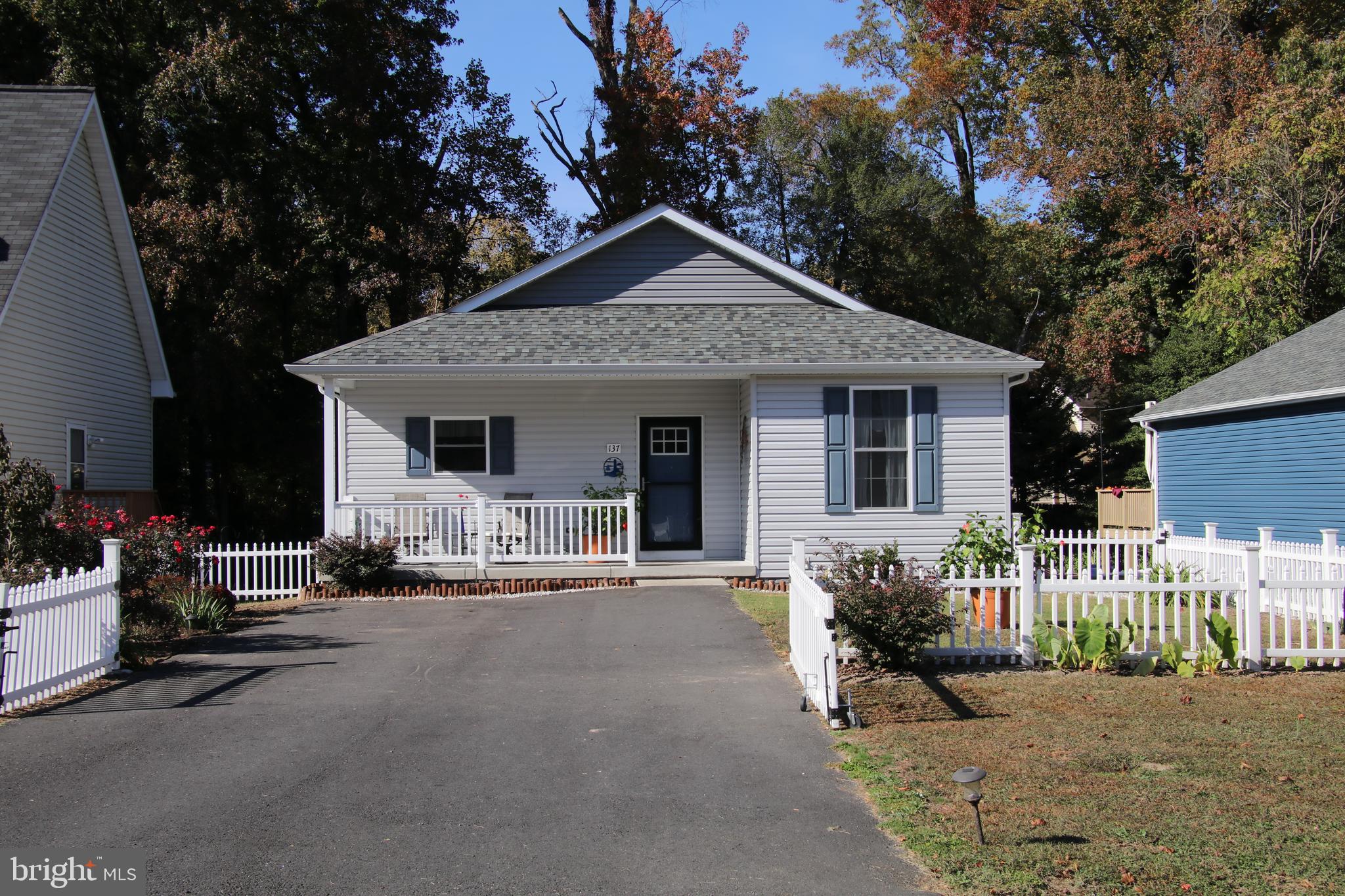 137 12th Street Colonial Beach, VA 22443 - Photo 3 of 66 a front view of a house with yard outdoor seating and green space