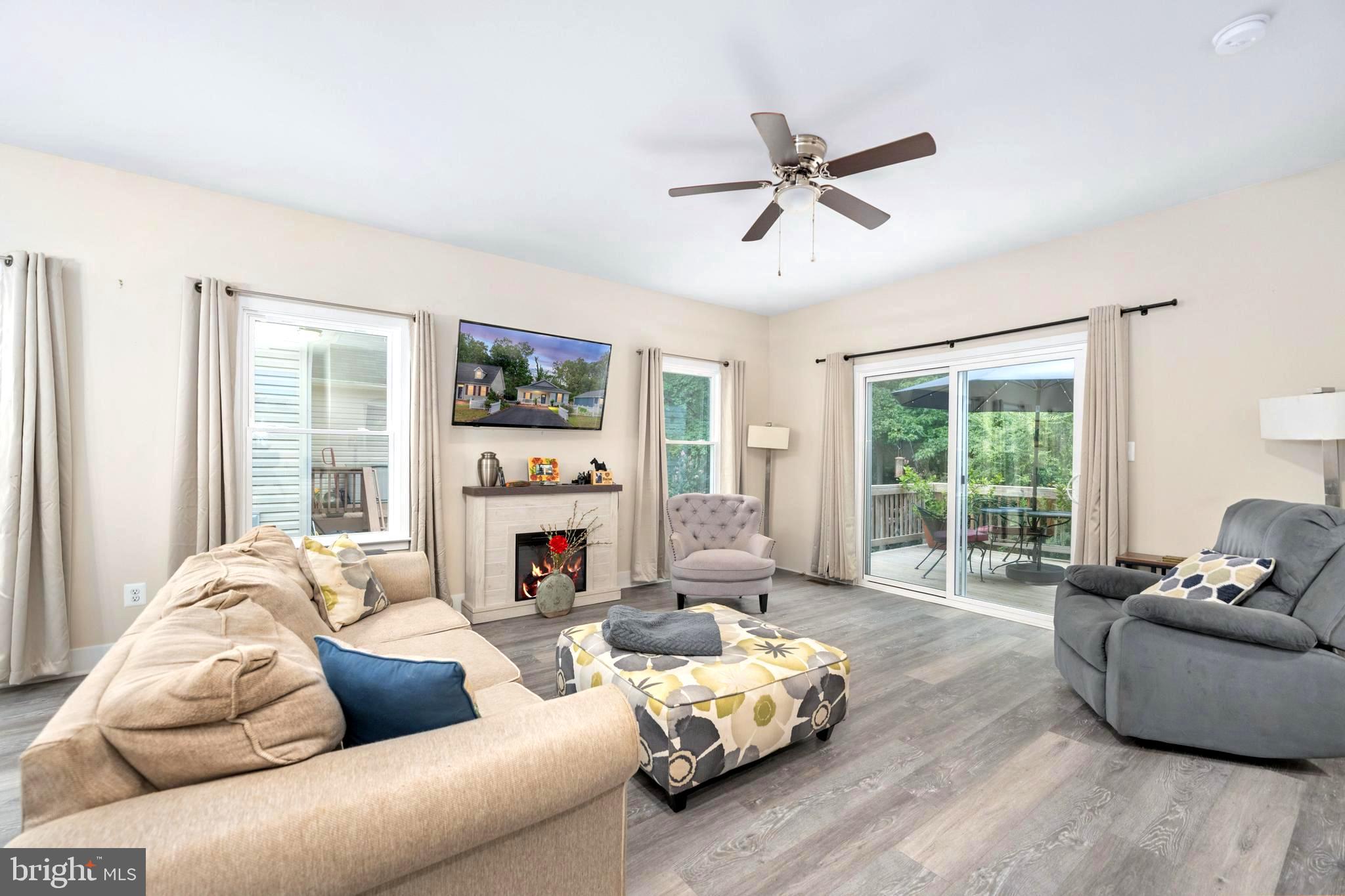 137 12th Street Colonial Beach, VA 22443 - Photo 32 of 66 a living room with furniture flat screen tv and a large window