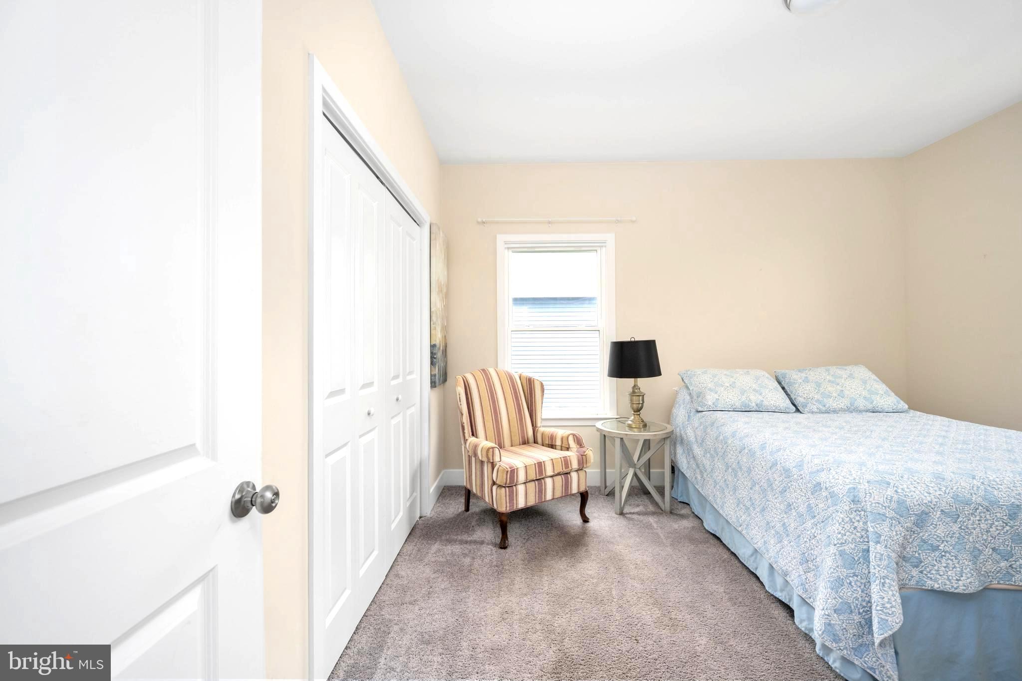 137 12th Street Colonial Beach, VA 22443 - Photo 36 of 66 a bedroom with a bed wooden floor and chair