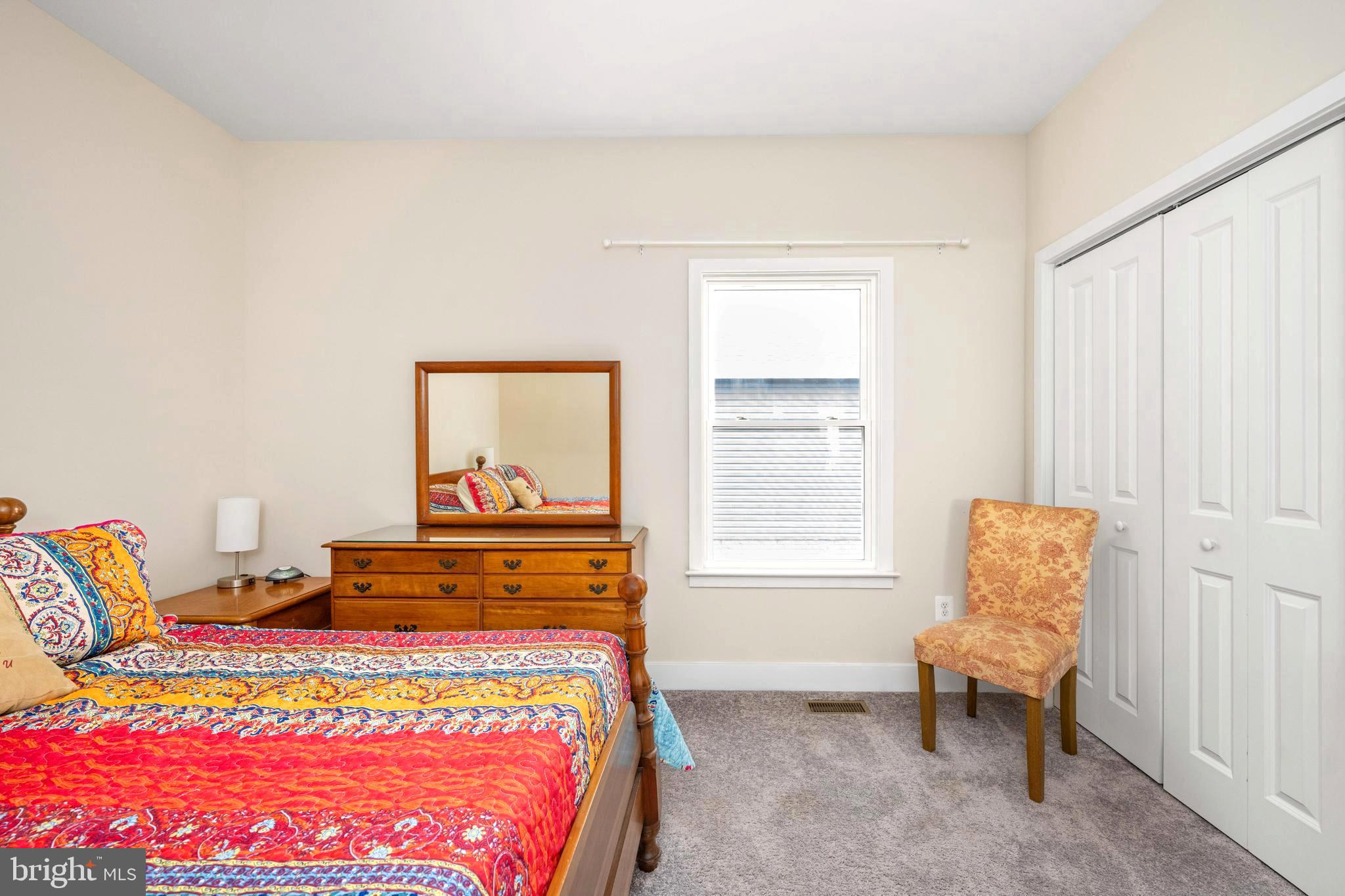 137 12th Street Colonial Beach, VA 22443 - Photo 40 of 66 a bed sitting in a bedroom next to a window