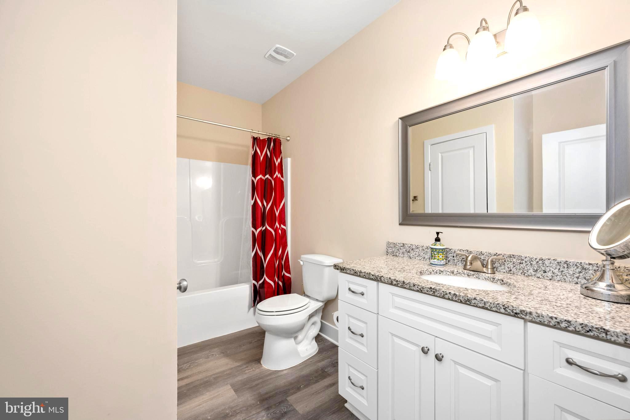 137 12th Street Colonial Beach, VA 22443 - Photo 41 of 66 a bathroom with a granite countertop sink and a mirror