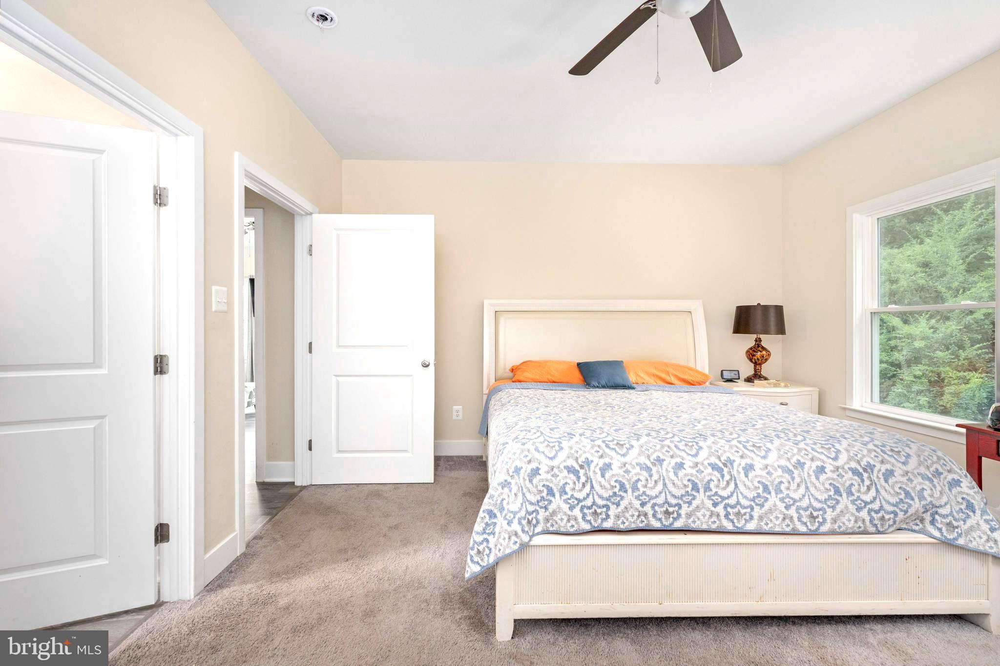 137 12th Street Colonial Beach, VA 22443 - Photo 45 of 66 a bedroom with a bed and wooden floor