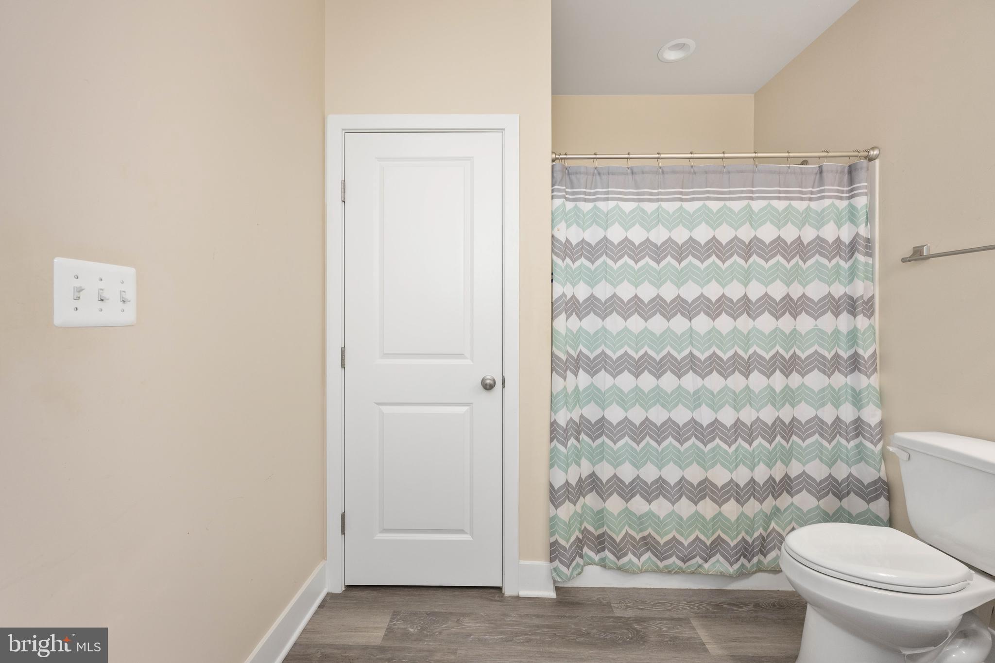137 12th Street Colonial Beach, VA 22443 - Photo 47 of 66 a bathroom with a granite countertop toilet and a shower