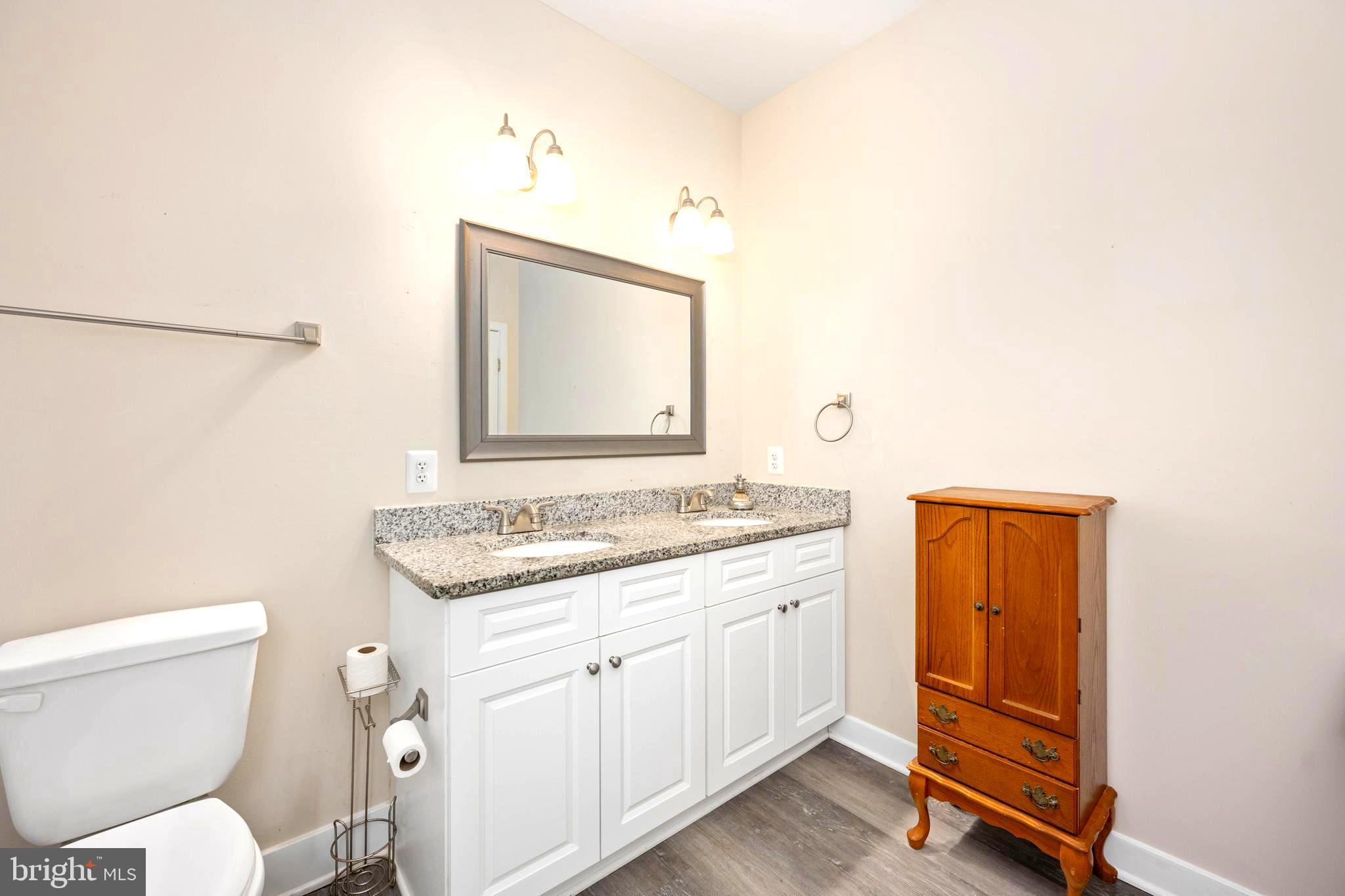 137 12th Street Colonial Beach, VA 22443 - Photo 48 of 66 a bathroom with a toilet sink and mirror
