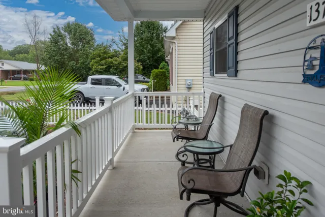 a front view of a house with a yard table and chairs