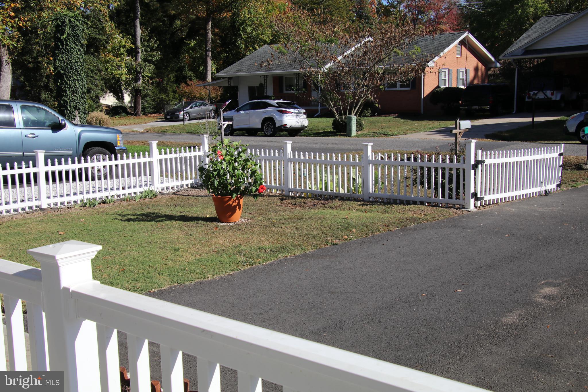 137 12th Street Colonial Beach, VA 22443 - Photo 8 of 66 a view of a house with wooden fence next to a yard