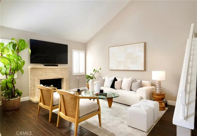 a living room with furniture a fireplace and a flat screen tv