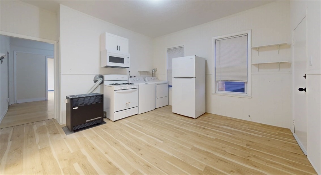 18 Elizabeth Street Worcester, MA 01605 - Photo 9 of 13 a kitchen with stainless steel appliances granite countertop a refrigerator and a stove