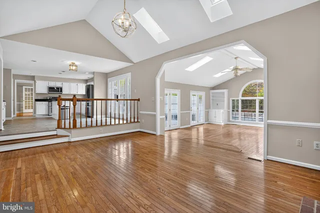 wooden floor fireplace and windows in an empty room