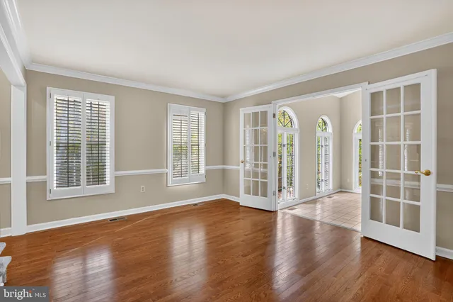 a view of a livingroom with wooden floor and a large window