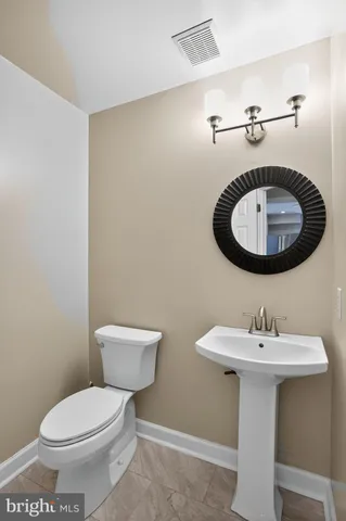 a bathroom with a toilet sink and shower