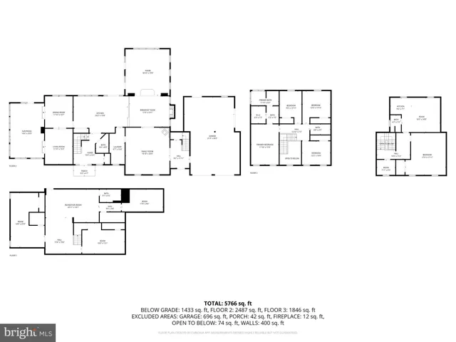 a large white kitchen with a large window and stainless steel appliances