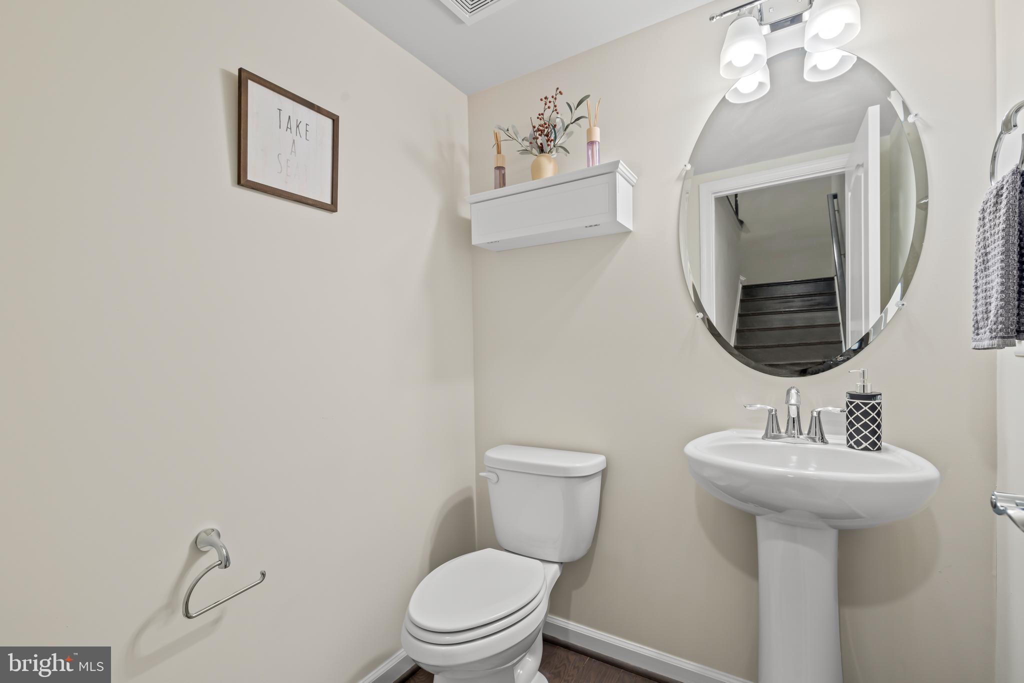 7715 Cresap Lane Hanover, MD 21076 - Photo 17 of 42 a bathroom with a toilet sink and mirror