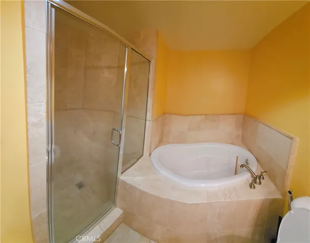 a bathroom with a white bath tub and shower