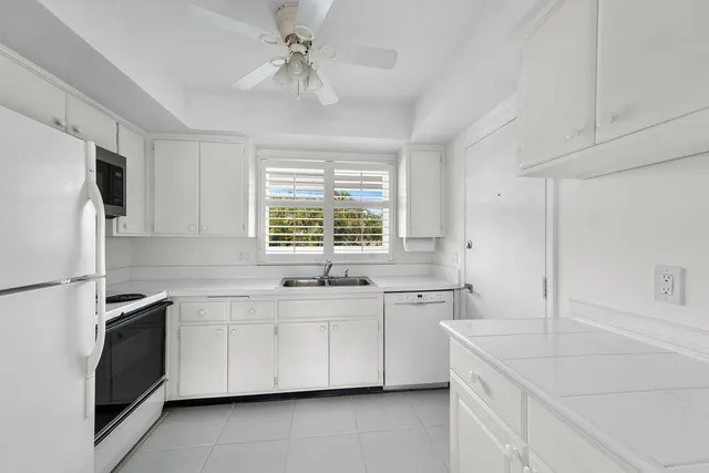 a kitchen with a sink stove and refrigerator