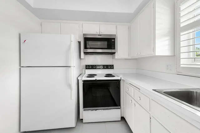 a kitchen with a refrigerator and a sink