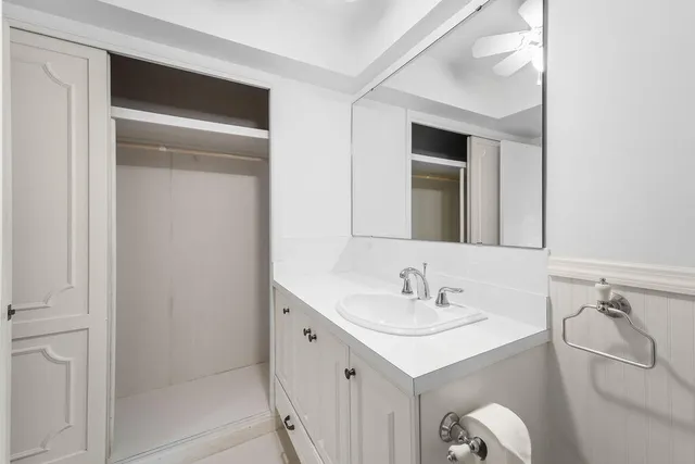 a bathroom with a sink vanity and a mirror