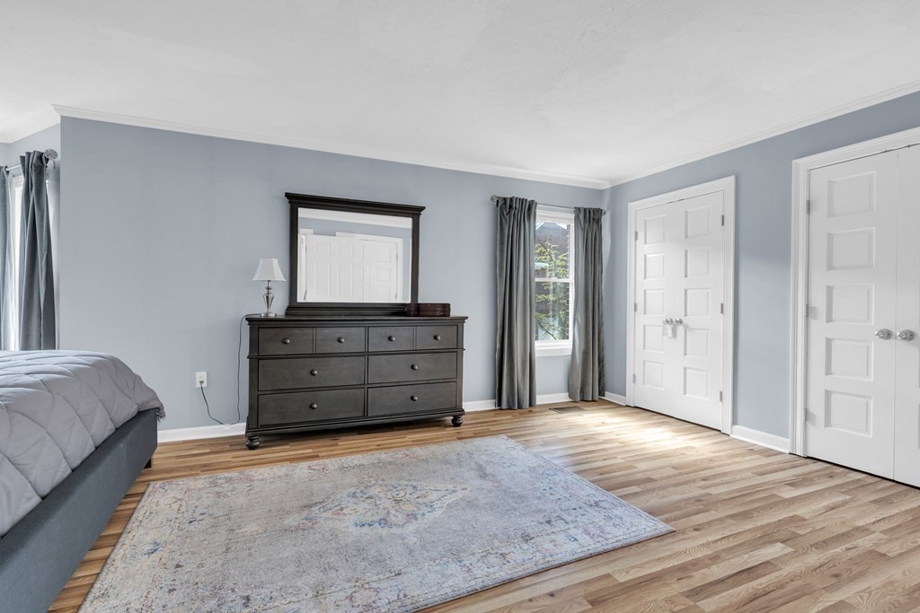 166 Quincy Shore Drive, Unit 108 Quincy, MA 02171 - Photo 15 of 36 a room with a dresser and a mirror
