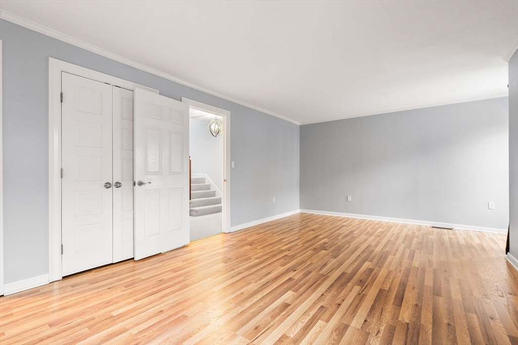 166 Quincy Shore Drive, Unit 108 Quincy, MA 02171 - Photo 16 of 36 a view of empty room with wooden floor