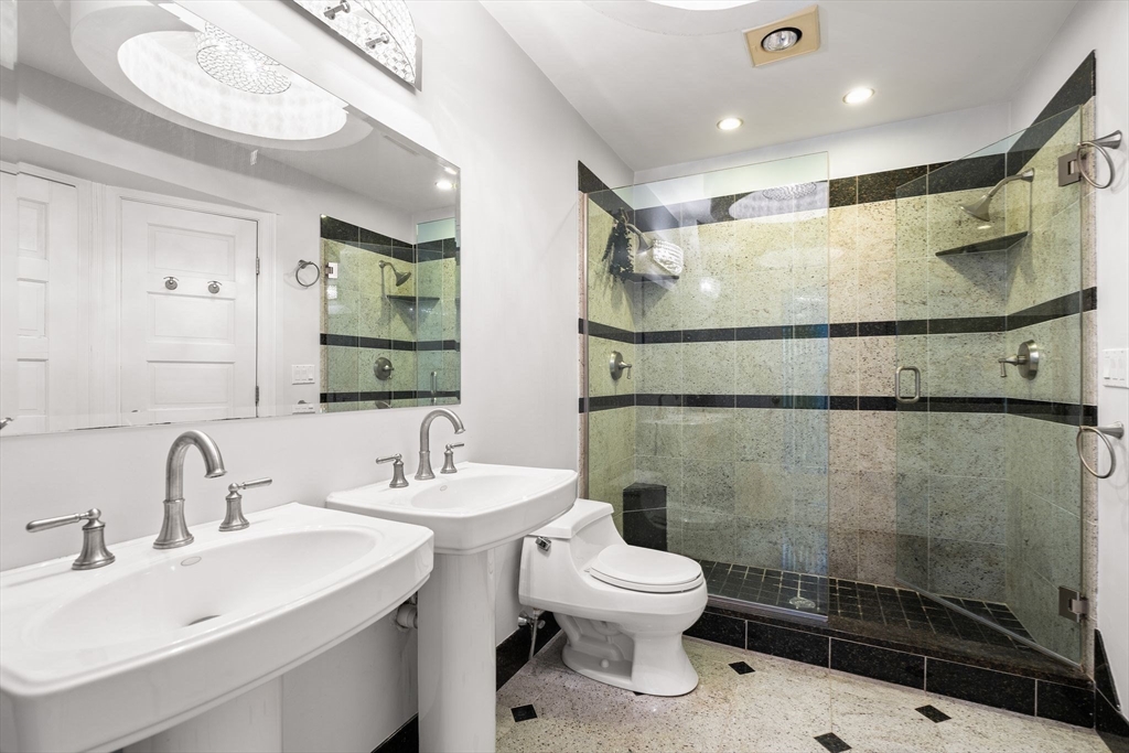 166 Quincy Shore Drive, Unit 108 Quincy, MA 02171 - Photo 18 of 36 a bathroom with a sink toilet and shower