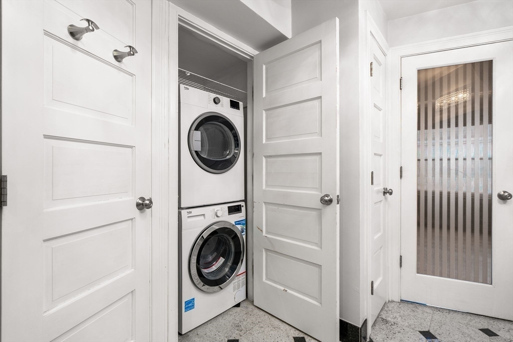 166 Quincy Shore Drive, Unit 108 Quincy, MA 02171 - Photo 19 of 36 a view of a hallway with washer and dryer
