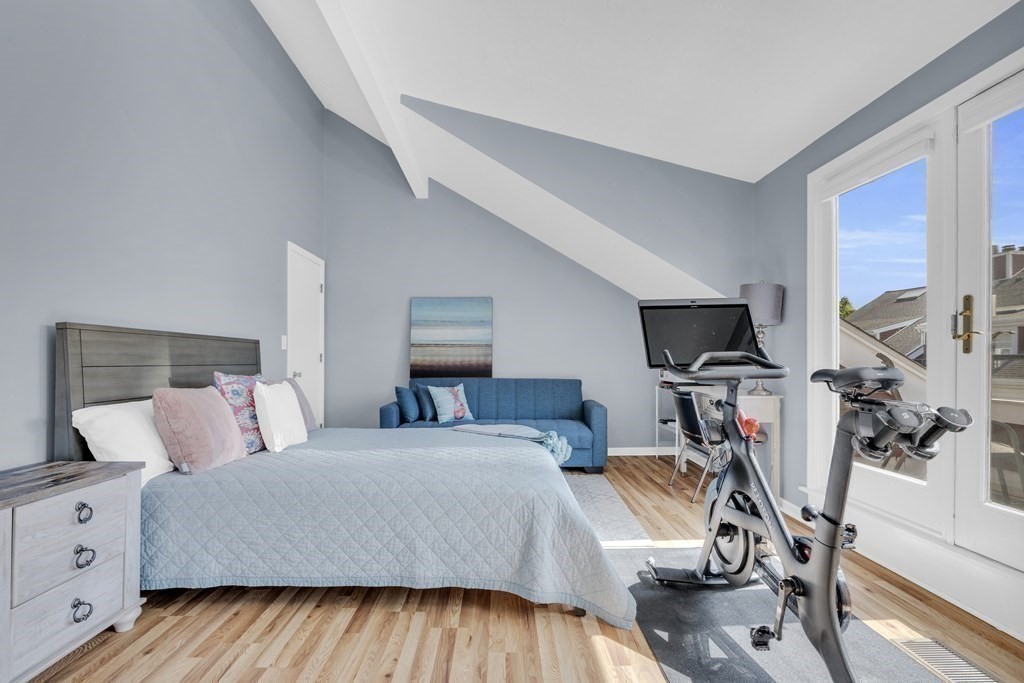 166 Quincy Shore Drive, Unit 108 Quincy, MA 02171 - Photo 21 of 36 a bedroom with a bed and a flat screen tv