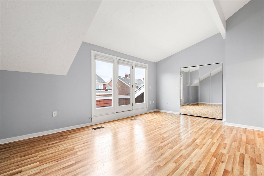 166 Quincy Shore Drive, Unit 108 Quincy, MA 02171 - Photo 24 of 36 wooden floor in an empty room with a window