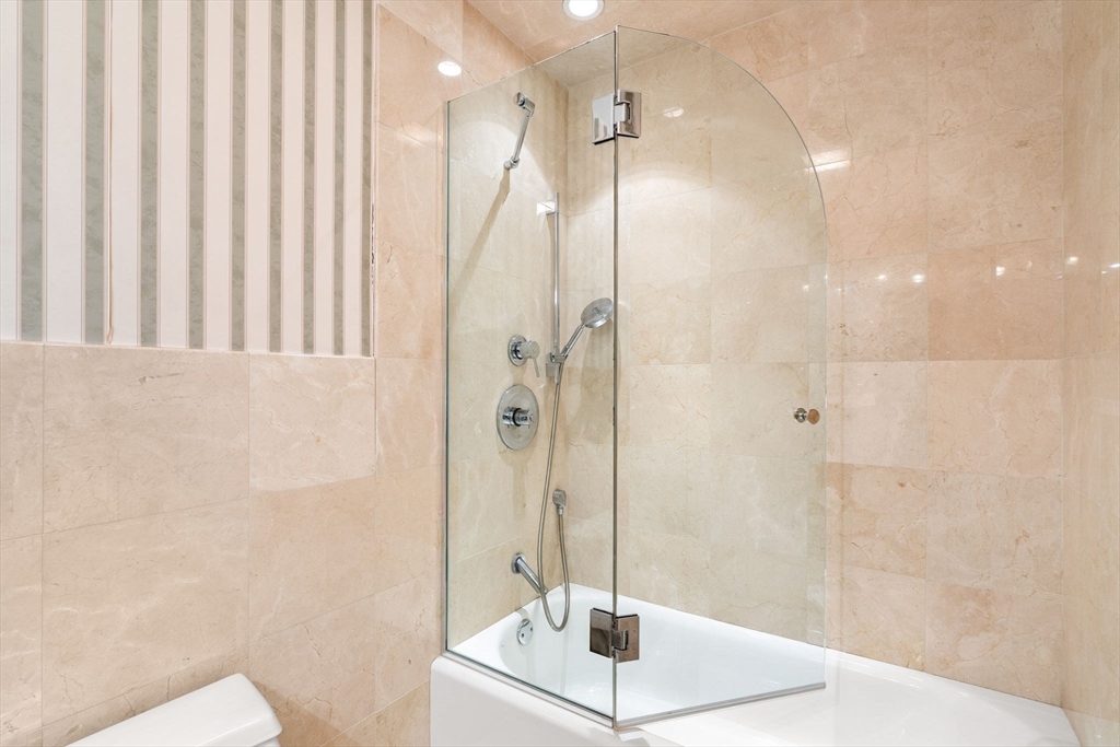 166 Quincy Shore Drive, Unit 108 Quincy, MA 02171 - Photo 27 of 36 a bathroom with a shower and a sink