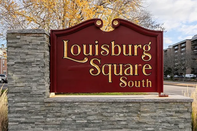 a sign that is on a brick wall