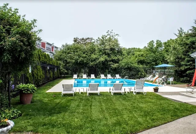 a view of a chair and table in the garden