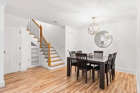 a view of a dining area with furniture and wooden floor