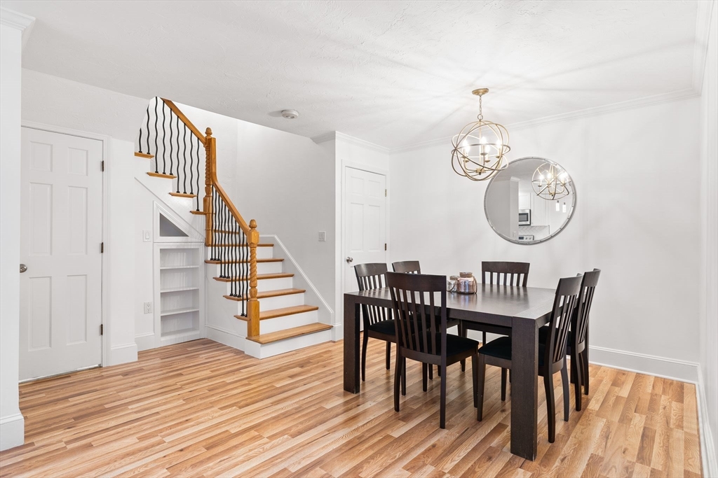 166 Quincy Shore Drive, Unit 108 Quincy, MA 02171 - Photo 7 of 36 a view of a dining area with furniture and wooden floor