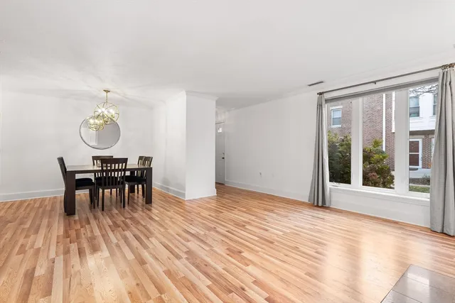a view of a work space with a table and chairs