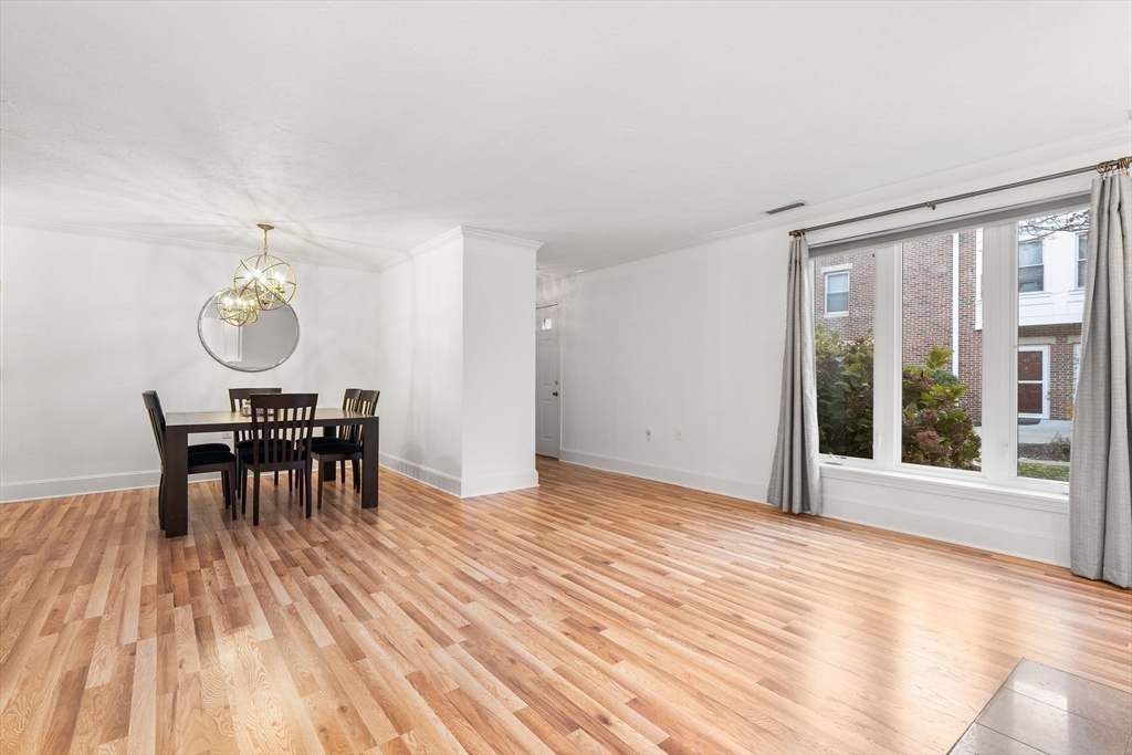 166 Quincy Shore Drive, Unit 108 Quincy, MA 02171 - Photo 8 of 36 a view of a work space with a table and chairs