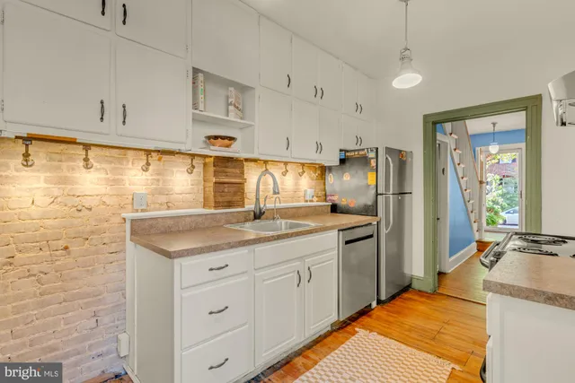 a kitchen with stainless steel appliances granite countertop a sink and cabinets