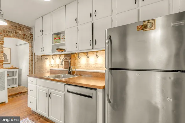 a white refrigerator freezer sitting in a kitchen