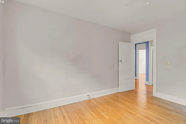 a view of an empty room and wooden floor