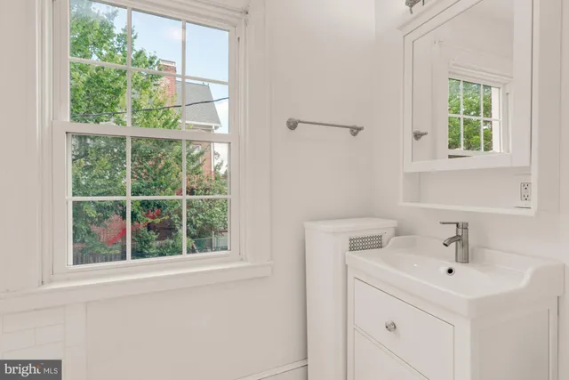 a bathroom with a sink and a window