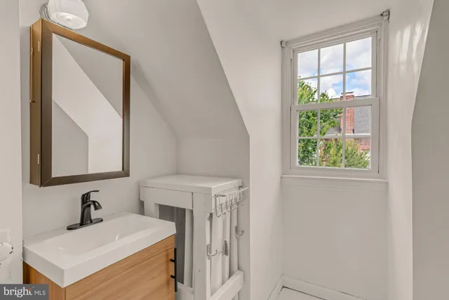 a bathroom with a sink a vanity and a mirror