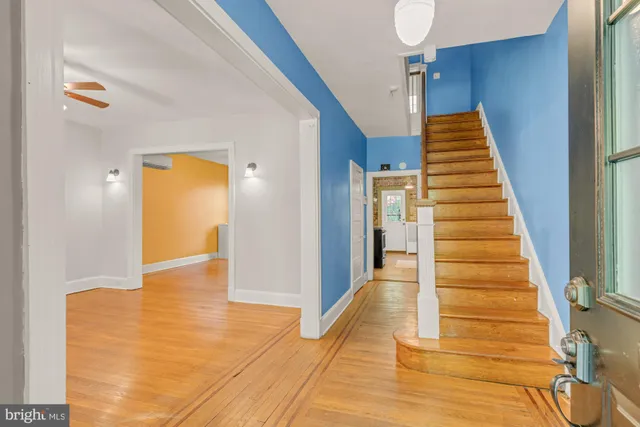 a view of a hallway view with wooden floor and staircase