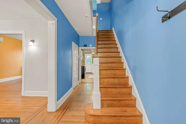 a view of entryway and gallery with wooden floor