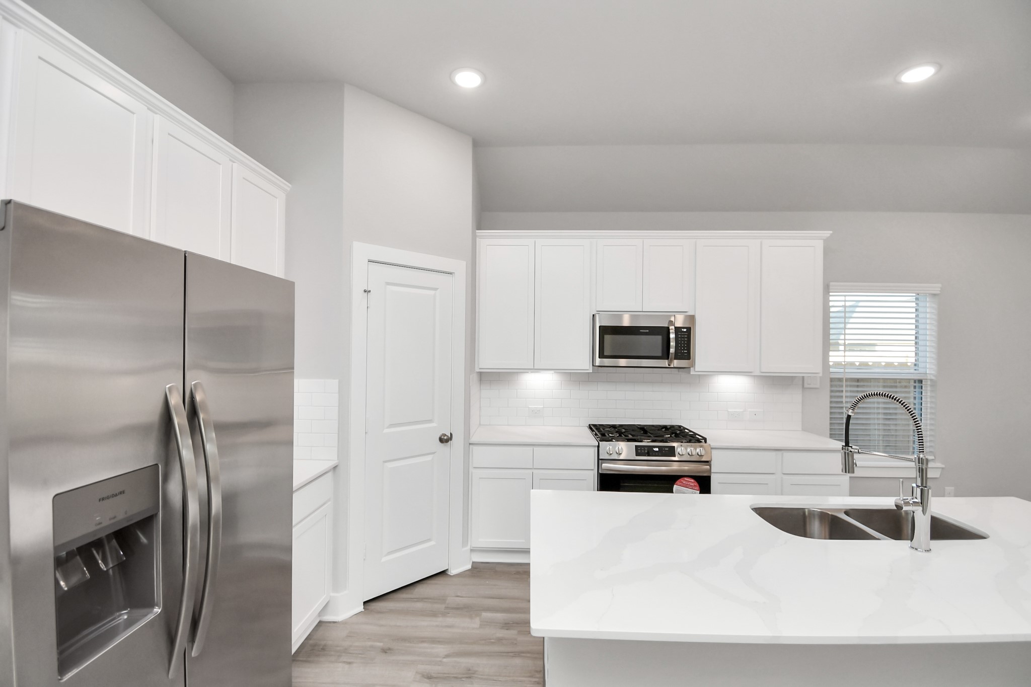 7510 Terramar Bay Lane Cypress, TX 77433 - Photo 5 of 20 a kitchen with stainless steel appliances a refrigerator sink and white cabinets
