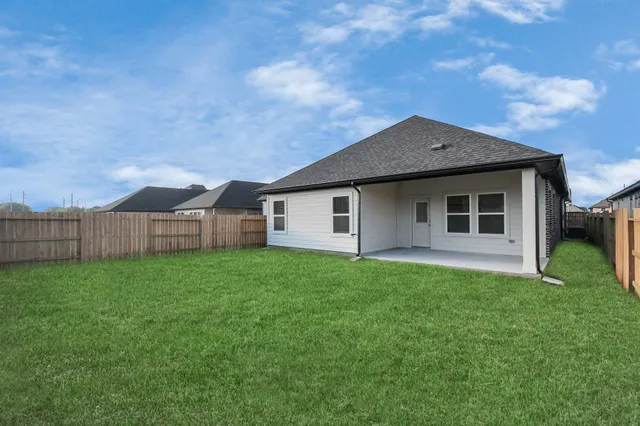a kitchen with a sink windows and wooden floor