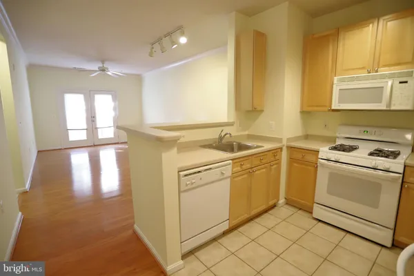 a kitchen with a refrigerator a stove top oven a sink and dishwasher